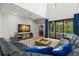 Open living room with soaring ceiling, large leather couch, and view of pool at 2671 Lakebreeze S Ln, Clearwater, FL 33759