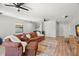 Open living room featuring hardwood floors, neutral walls, and multiple ceiling fans at 2671 Lakebreeze S Ln, Clearwater, FL 33759