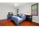 Nicely finished bedroom features wood floors, a ceiling fan, and a view of the TV and dresser at 2671 Lakebreeze S Ln, Clearwater, FL 33759