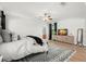 Spacious bedroom with hardwood floors, ceiling fan, decorative rug, and a walk-in closet entrance at 2671 Lakebreeze S Ln, Clearwater, FL 33759