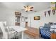 Versatile room with surfboard decor, a ceiling fan and a white desk perfect for office or creative space at 2671 Lakebreeze S Ln, Clearwater, FL 33759