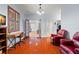 Office area featuring hardwood floors, a desk, and a comfortable red leather chair at 2671 Lakebreeze S Ln, Clearwater, FL 33759