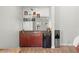 Home wet bar with dark wood cabinets, granite countertops and mirrored backsplash at 2671 Lakebreeze S Ln, Clearwater, FL 33759