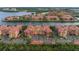 Lovely aerial of condo buildings with barrel tile roofs, lush landscaping, and convenient parking at 2741 Via Cipriani # 931A, Clearwater, FL 33764