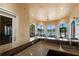 Features a bar area with countertop seating that overlooks views of the pool and common outdoor area at 2741 Via Cipriani # 931A, Clearwater, FL 33764