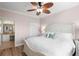 Bright bedroom featuring a ceiling fan, a spacious bed, and an ensuite bathroom at 2741 Via Cipriani # 931A, Clearwater, FL 33764