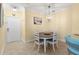 Cozy dining area with decorative lighting fixture and neutral color palette at 2741 Via Cipriani # 931A, Clearwater, FL 33764