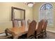 Formal dining room features a grand wooden table with seating for six under a chandelier with a large mirror at 2741 Via Cipriani # 931A, Clearwater, FL 33764
