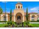 Villa d'Este building exterior features a beautiful entrance with pillars and manicured landscaping at 2741 Via Cipriani # 931A, Clearwater, FL 33764