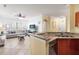 Bright living room features tile floors, neutral walls, and an eat-in kitchen with granite countertops at 2741 Via Cipriani # 931A, Clearwater, FL 33764