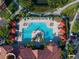 Aerial view of an inviting community pool area with ample seating and umbrellas at 2741 Via Cipriani # 931A, Clearwater, FL 33764