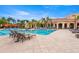 A gorgeous resort-style pool offers the ultimate in relaxation and fun under the sun, with lounge chairs, palm trees, and volleyball net at 2741 Via Cipriani # 931A, Clearwater, FL 33764