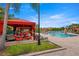 Beautiful pool area featuring lounge chairs, cabanas, and lush landscaping at 2741 Via Cipriani # 931A, Clearwater, FL 33764