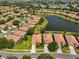 Beautiful aerial view of single-Gathering homes with red tile roofs around a lake in the Del Webb community at 336 Silver Falls Dr, Apollo Beach, FL 33572