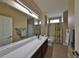 Bright bathroom features a long countertop, large mirror, tub, and shower at 336 Silver Falls Dr, Apollo Beach, FL 33572