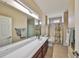 Bright bathroom features a long countertop, large mirror, tub, and shower at 336 Silver Falls Dr, Apollo Beach, FL 33572