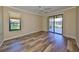 Bright bedroom with hardwood floors, a ceiling fan, and sliding doors to the outside at 336 Silver Falls Dr, Apollo Beach, FL 33572