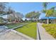 Outdoor bocce ball court with artificial turf and landscaping. Canopy with outdoor furniture in the background at 336 Silver Falls Dr, Apollo Beach, FL 33572