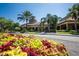 Clubhouse exterior featuring vibrant landscaping and tropical palms at 336 Silver Falls Dr, Apollo Beach, FL 33572