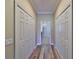 Hallway with storage closets and hardwood floors at 336 Silver Falls Dr, Apollo Beach, FL 33572