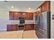 Modern kitchen with dark cabinets, granite countertops, and stainless steel appliances at 336 Silver Falls Dr, Apollo Beach, FL 33572