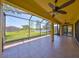 Spacious screened-in lanai overlooking a serene backyard with views of a tranquil lake and lush greenery at 336 Silver Falls Dr, Apollo Beach, FL 33572