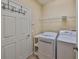 Laundry room area with washer, dryer, wire shelving and door at 336 Silver Falls Dr, Apollo Beach, FL 33572