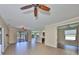 Open-concept living room with tile floors, ceiling fan, and sliding glass doors leading to the lanai at 336 Silver Falls Dr, Apollo Beach, FL 33572