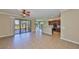 Open-concept living space with tile flooring, seamlessly connecting the living, dining, and kitchen areas for modern living at 336 Silver Falls Dr, Apollo Beach, FL 33572