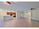 Spacious living area with tile floors, ceiling fan, and seamless flow into the open kitchen and dining areas at 336 Silver Falls Dr, Apollo Beach, FL 33572