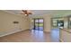 Bright living room features tile flooring, fan, and sliding glass doors to the outside at 336 Silver Falls Dr, Apollo Beach, FL 33572