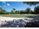 Community putting green featuring manicured grass and shade trees in a residential neighborhood at 336 Silver Falls Dr, Apollo Beach, FL 33572