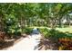 Paved trail for walking and biking winds through manicured landscaping and lush vegetation in the Del Webb community at 336 Silver Falls Dr, Apollo Beach, FL 33572
