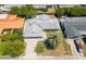 This aerial view showcases the home's roof, driveway, and surrounding lush landscaping at 3654 Warbler Dr, New Port Richey, FL 34652