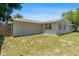 The home features a spacious backyard with a wooden fence and ample green space at 3654 Warbler Dr, New Port Richey, FL 34652