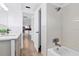 Bathroom featuring dual vanity, tub and shower combo, and doorway view of kitchen at 3654 Warbler Dr, New Port Richey, FL 34652