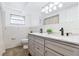 Bright bathroom featuring a double sink vanity with marble countertops, hardwood floors and a separate shower at 3654 Warbler Dr, New Port Richey, FL 34652