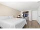 This bedroom features a large closet, neutral walls, wood-look floors, and a cozy bed at 3654 Warbler Dr, New Port Richey, FL 34652