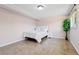 Cozy bedroom showcases a comfortable bed, side table, hardwood floors and ample natural light at 3654 Warbler Dr, New Port Richey, FL 34652