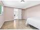 Cozy bedroom showcases a comfortable bed, hardwood floors, and an open door view to the dining room at 3654 Warbler Dr, New Port Richey, FL 34652