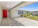 Covered front porch with tiled flooring and a bright red front door at 3654 Warbler Dr, New Port Richey, FL 34652
