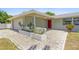 Inviting front porch with brick pavers and a red front door at 3654 Warbler Dr, New Port Richey, FL 34652