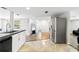 Open-concept kitchen with modern appliances and a view into the living room at 3654 Warbler Dr, New Port Richey, FL 34652