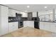 Modern kitchen with white cabinets, stainless steel appliances, and a tiled backsplash at 3654 Warbler Dr, New Port Richey, FL 34652