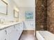Bathroom with marble floors, double vanity, and a shower-tub combination at 402 S Barbara Ln, Tampa, FL 33609