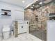 Luxurious bathroom featuring a modern toilet, sleek vanity, and a spacious glass-enclosed shower at 402 S Barbara Ln, Tampa, FL 33609