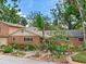 A charming brick home featuring a colorful front yard garden with whimsical decorations and stone accents at 402 S Barbara Ln, Tampa, FL 33609