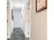 Clean, well-lit hallway with tile floors and white doors, connecting different areas of the home at 402 S Barbara Ln, Tampa, FL 33609