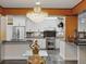 Modern kitchen features white cabinets, granite countertops, stainless steel appliances, and custom backsplash at 402 S Barbara Ln, Tampa, FL 33609
