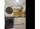 Laundry room with sink and black and white stacked washer/dryer at 402 S Barbara Ln, Tampa, FL 33609